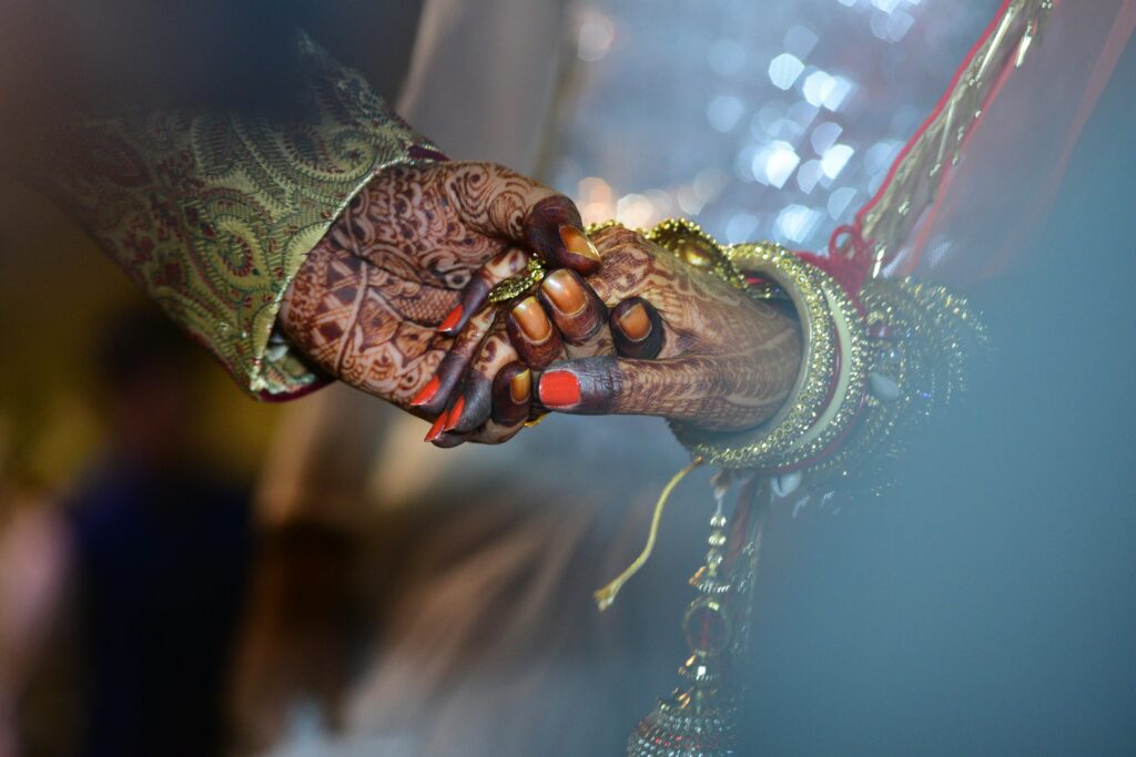Gallery A beautiful capture of mehndi-decorated hands symbolizing love and tradition in a wedding ceremony.